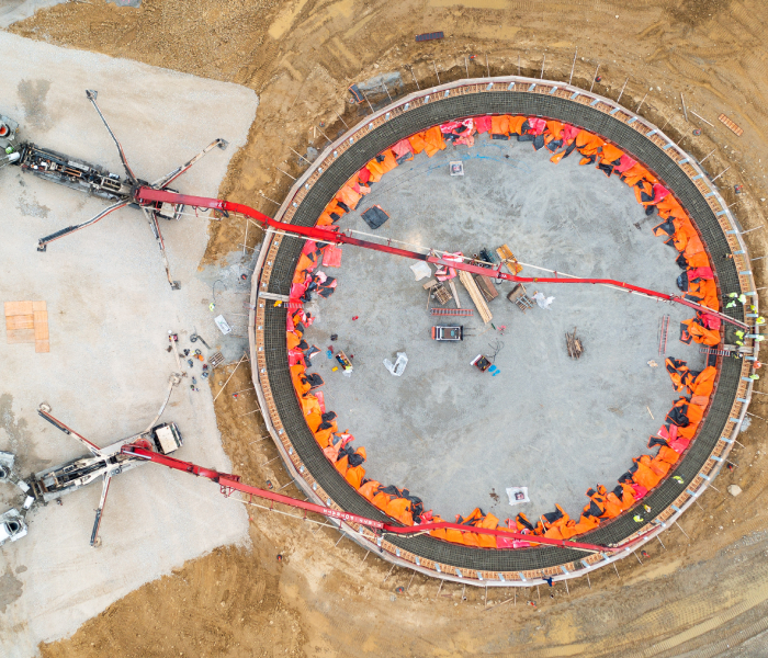 Overhead view of crews pouring concrete for the LNG tank foundation