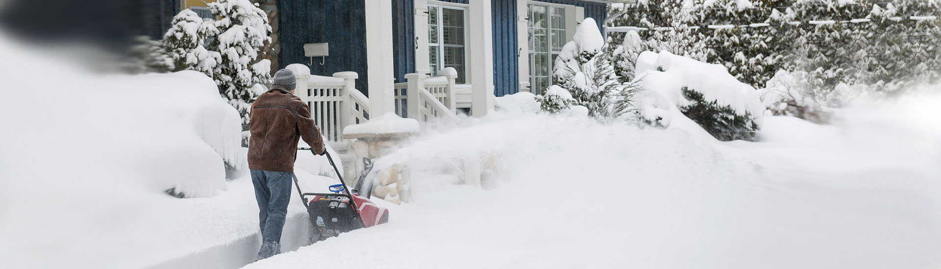 man snow blowing