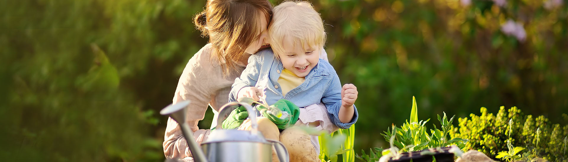 mother and child gardening and smiling