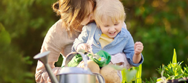 mother and child gardening and smiling