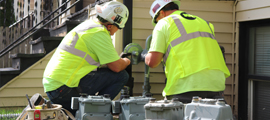 workers replacing natural gas meters