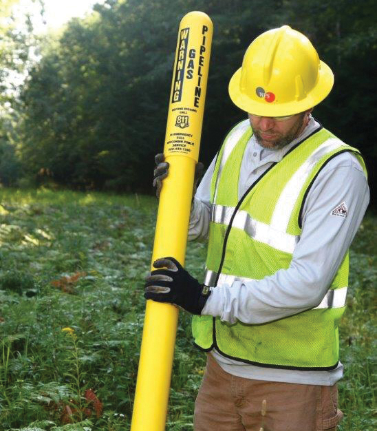 employee placing facility natural gas markers